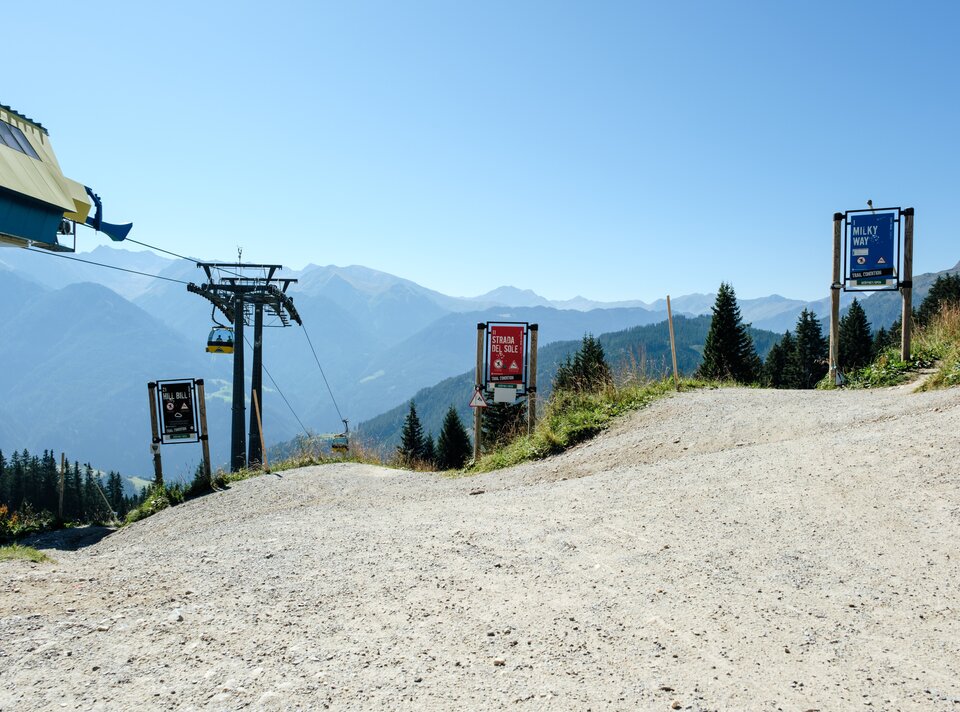View of a cable car and valley. Clear air and mountains in the background.