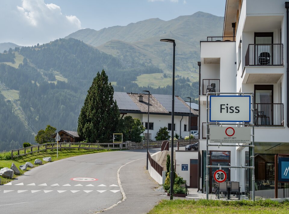 Panorama of Fiss featuring mountains and a quiet road.